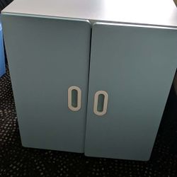 White Cupboard With A Shelf And Colored Cupboard Doors