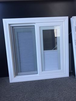 Sliding vinyl window With shades between glass