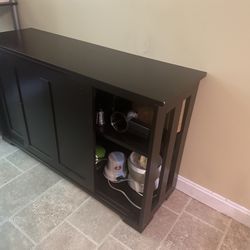 Black Wooden Credenza With Shelves Having Sliding Doors