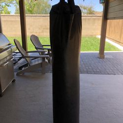 Solid Black Punching bag, no branding, approx 100lbs, bag is 5ft, includes hardware.