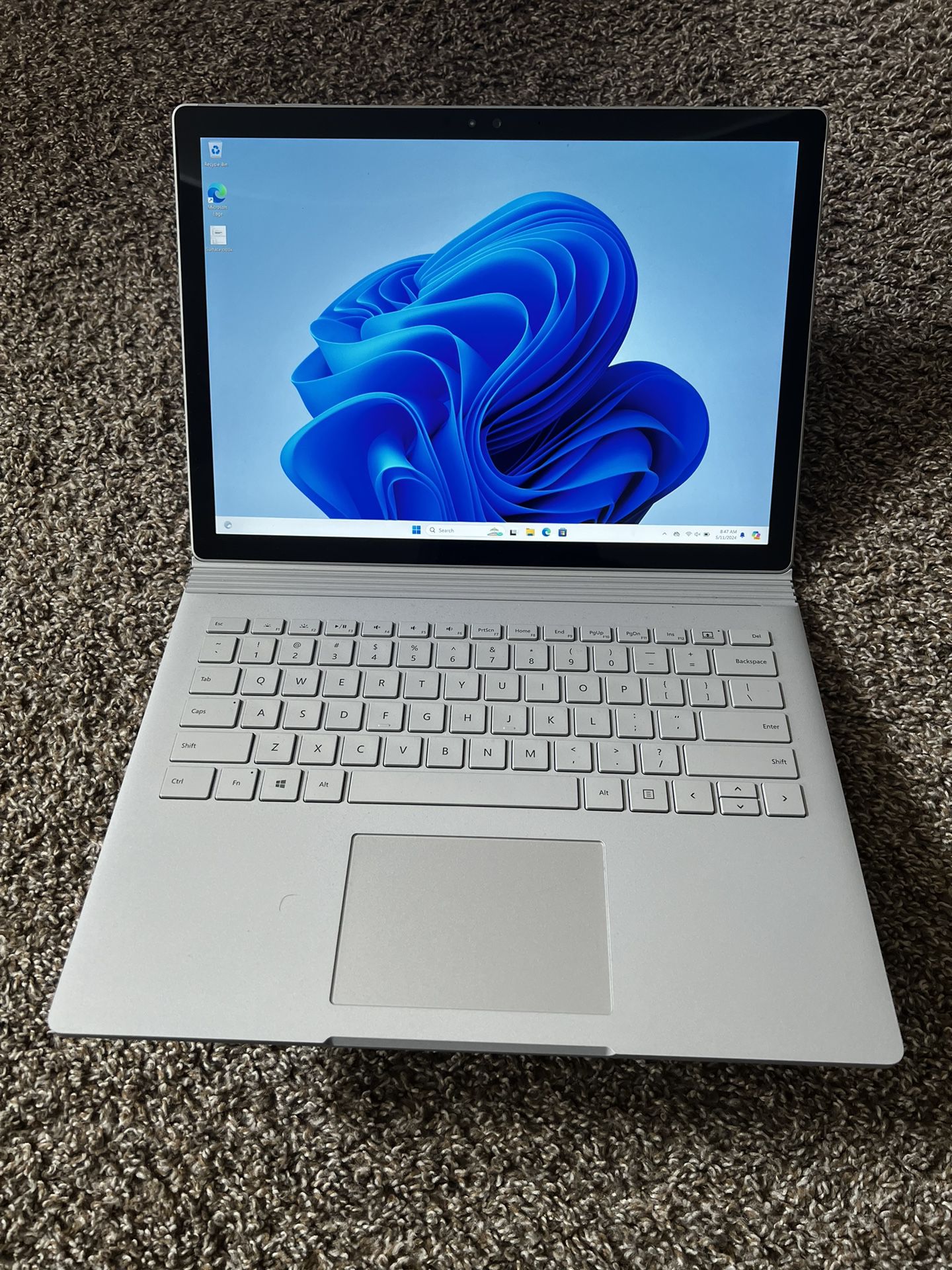 Gray Microsoft surface book 1 with keyboard and charger