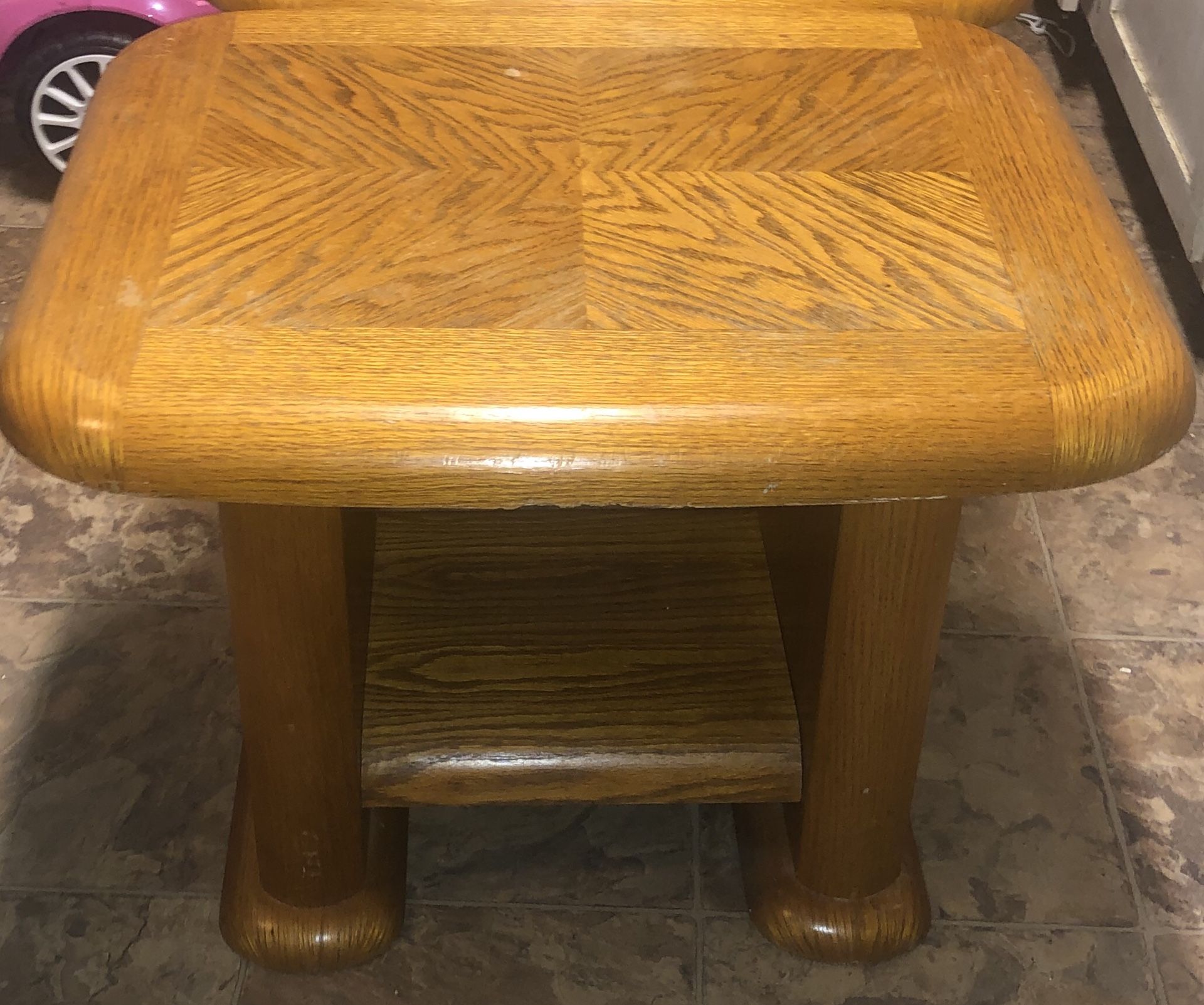 A lovely oak set of end tables with a down below small shelf.