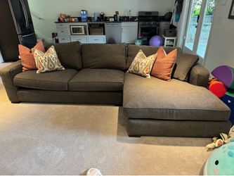 Dark grey section sofa with pillows