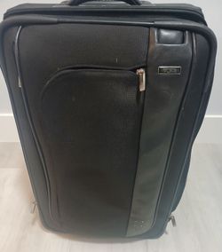 TUMI Luxury LUGGAGE. Rolling suitcase. Waterproof. Black. 24" height x 16" width x 12" deep.