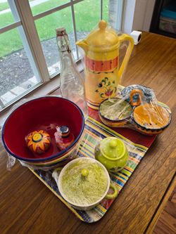 Pitcher,  Yellow Glass Tumblers,  Red Fiesta dishes,  Thermos