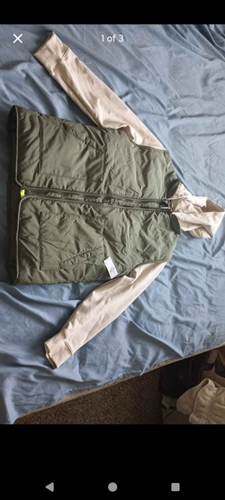 A hybrid puffer style vest