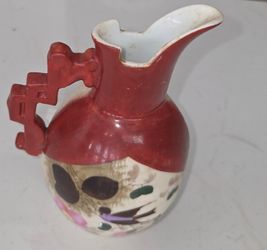 Vintage hand painted porcelain ewer pitcher, height 8", diameter 4". Ornate red geometric handle, hand‑painted bird and floral motif. cracks or repai