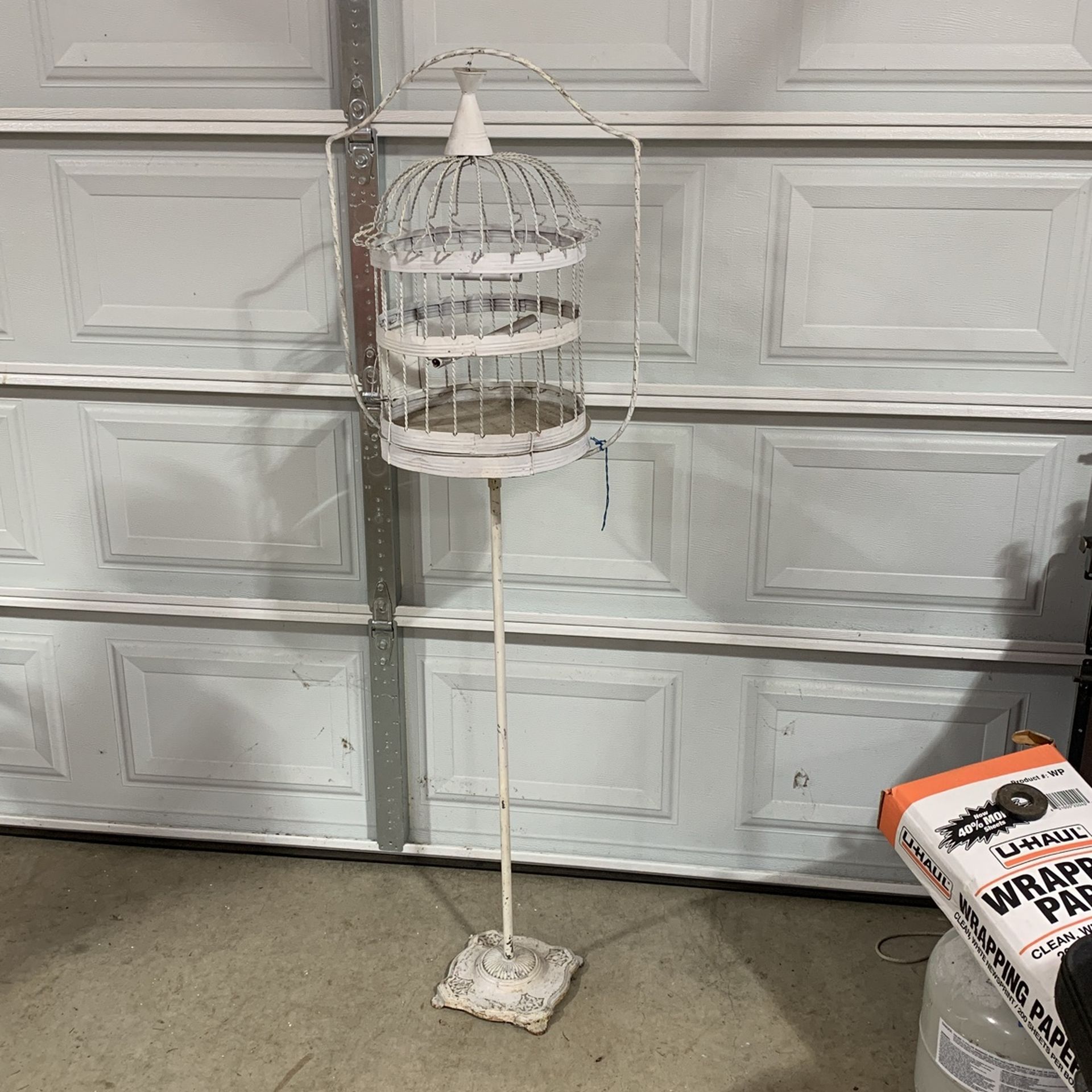 White birdcage on metal stand