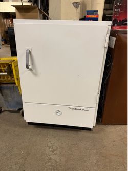 vintage white Westinghouse refrigerator is designed in the style of the 1940s or 1950s.