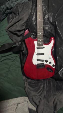 Electric guitar (MISSING CORD TO CONNECT SPEAKER TO GUATAR AND GUITAR IS MISSING A STRING