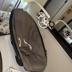 Baby items: nursing pillow, milk warmer, rocking chair, and new crib cover