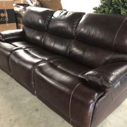 Aleena Leather Power Reclining Sofa with Power Headrest  Retails over $800 Previous floor model, still like new Small scuff (see last pic) on top back
