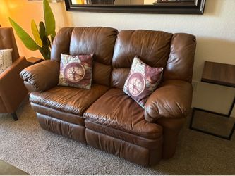 Brown leather love seat with dual recline