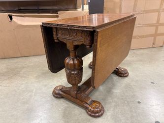 Antique Wooden Drop-Leaf Dining Table with Ornate Carved Trestle Base