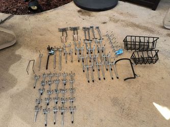 Assorted lot of pegboard metal hooks and baskets