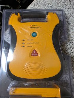 Defibtech Lifeline Automated External Defibrillator (AED) in yellow and black, designed for emergency cardiac situations.