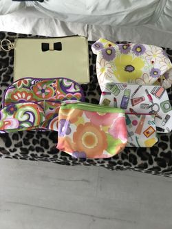 Assortment of cosmetic bags from Clinique and Victoria’s Secret