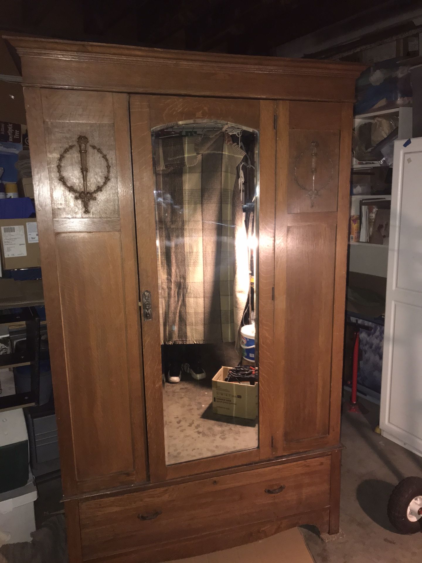 Antique armoire with beveled mirror. Approximately 78 inches tall by 48 inches wide and 24 inches deep. This comes apart into 3 separate pieces which