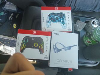 Shokz Open Run  and 2 Nintendo Switch 2 controllers
