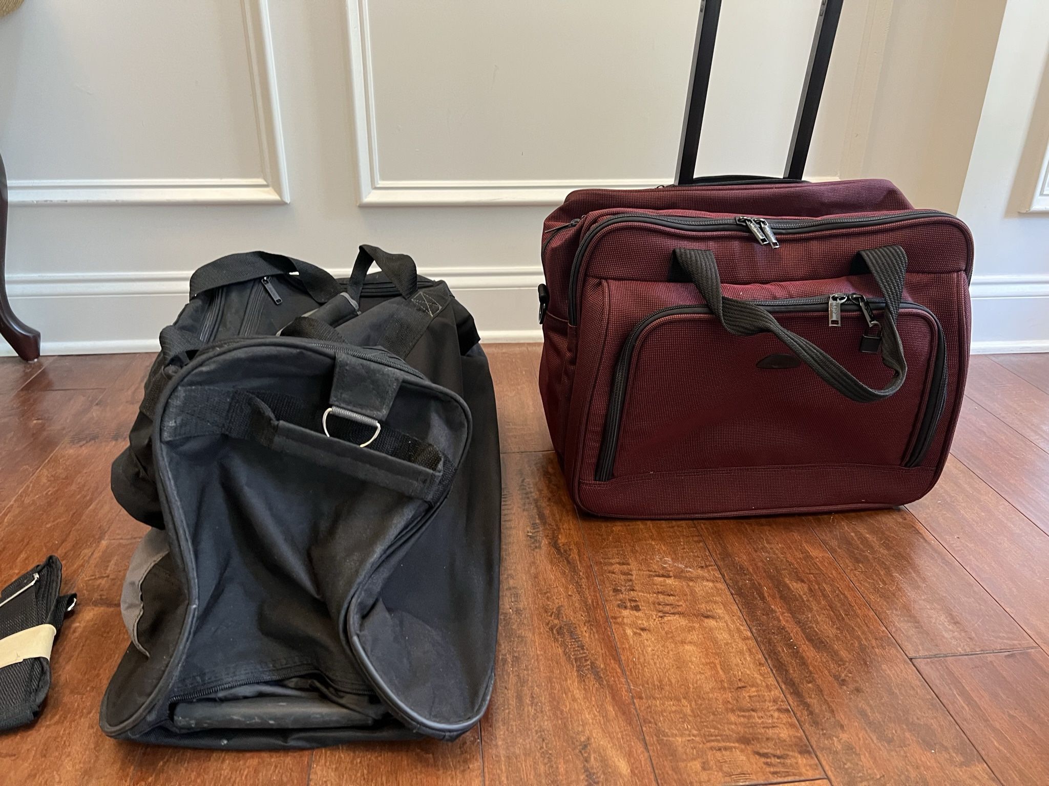 Two never used rolling travel bags