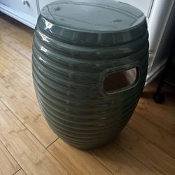 an emerald green ribbed ceramic garden stool or fountain base. 
