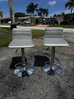 Set of 2 Adjustable Swivel Bar Stools – Gray Faux Leather, Chrome Base