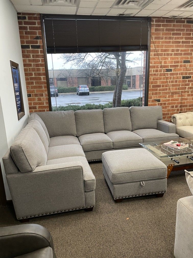 Gray fabric sectional sofa with storage ottoman