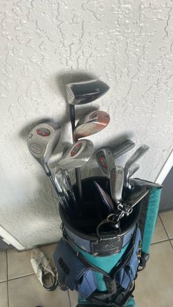 Golf clubs with bag and couple of balls and accessories