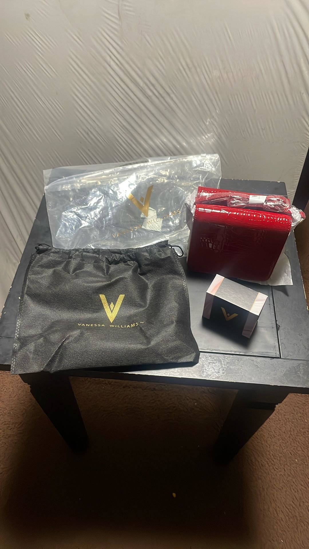 Vanessa Williams purse with a necklace and charm
