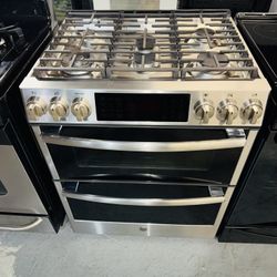 GE stainless steel stove with a receipt for a 90-day warranty