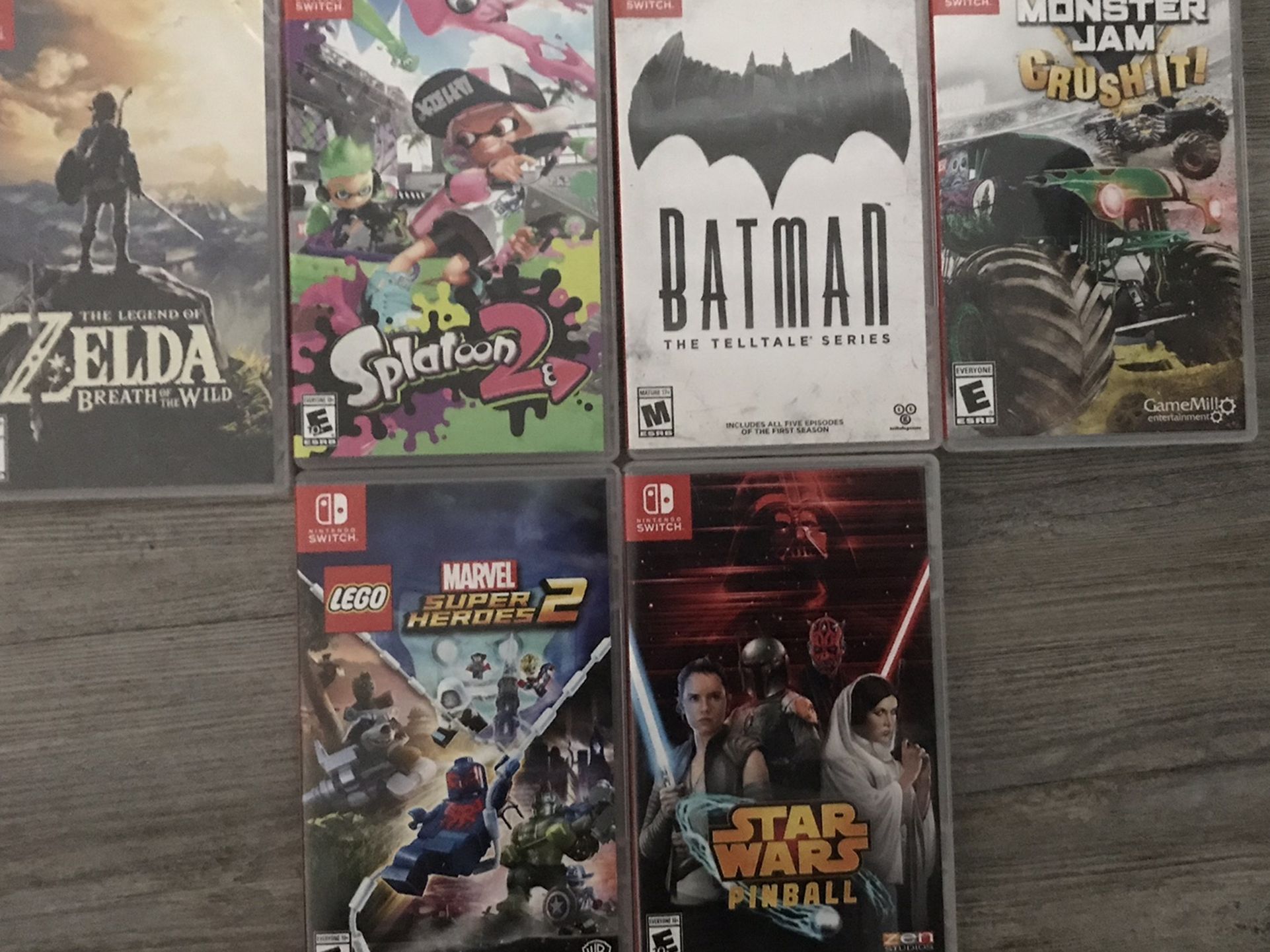 6 Nintendo Switch Games Which Are, Monster Jam, Splatoon 2, Marvel Super Heroes 2, Batman, Star Wars Pinball, And The Legend Of Zelda.