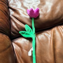 Soft plush bendable flower in the shape of a purple tulip with green stem