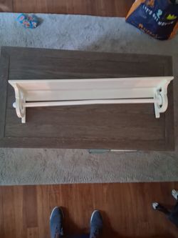 Shelf with bar to hang clothes from