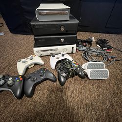 four Xbox 360, 360 S consoles, controllers