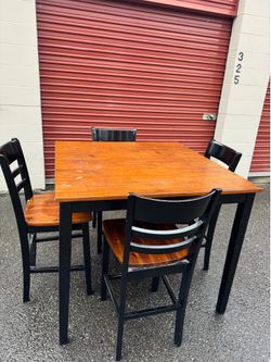 Square wooden high table and four chairs