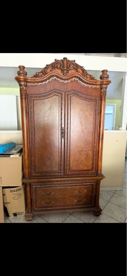 Ornate Wood Armoire with Carved Details