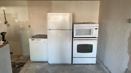 Complete set of white kitchen appliances.