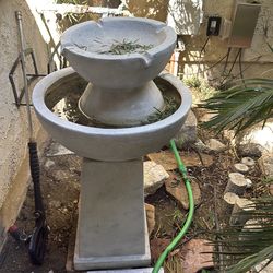 two-tier outdoor stone water fountain in good working condition. The style is classic garden décor,