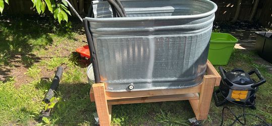 Dog bath on casters with a long drain hose