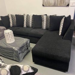 Black Comfortable Sectional With Designed Pillows 