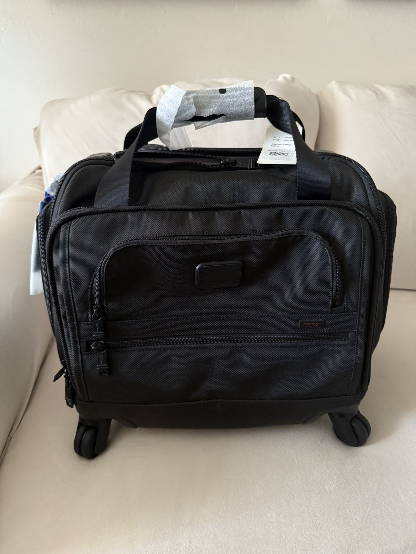 TUMI 4 wheeled carry on NEW w/tags