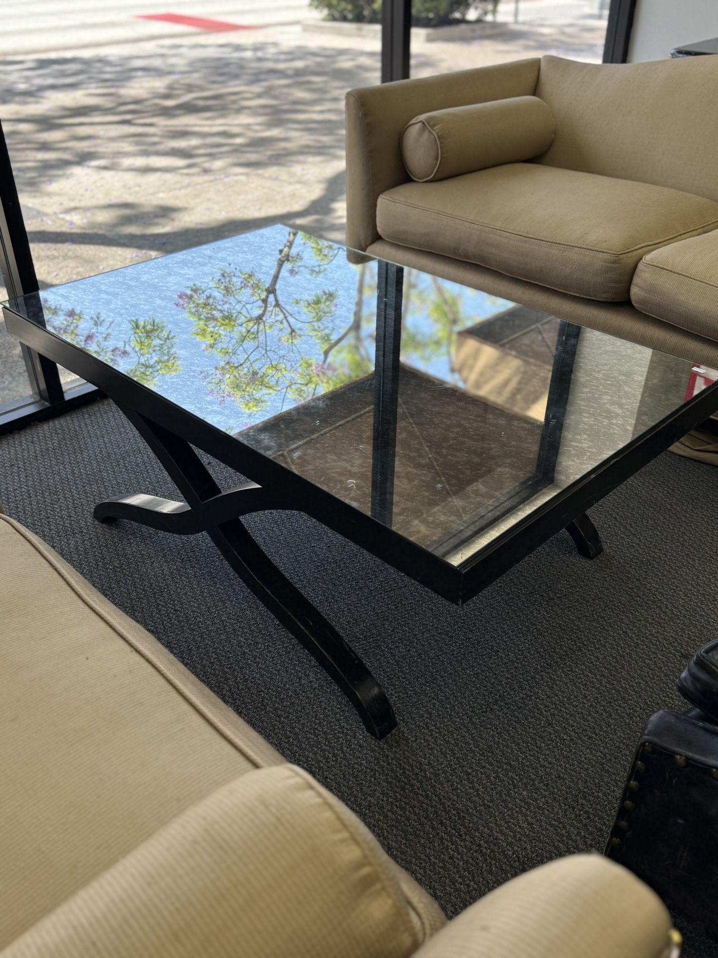 Mirror glass topped coffee table with black wooden base