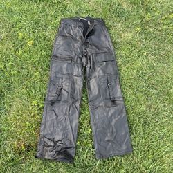 Y2K-inspired black faux leather cargo pants by LEGEND