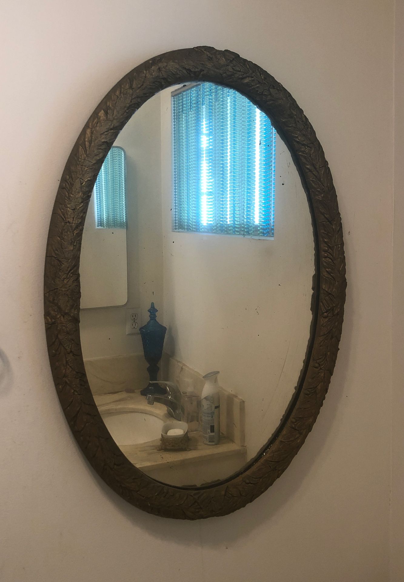 Oval gold lead mirror