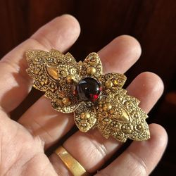 Vintage Gold Color Brooch With A Dark Red Gemstone 