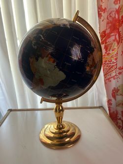 blue lapis gemstone globe with a gold tripod stand.
