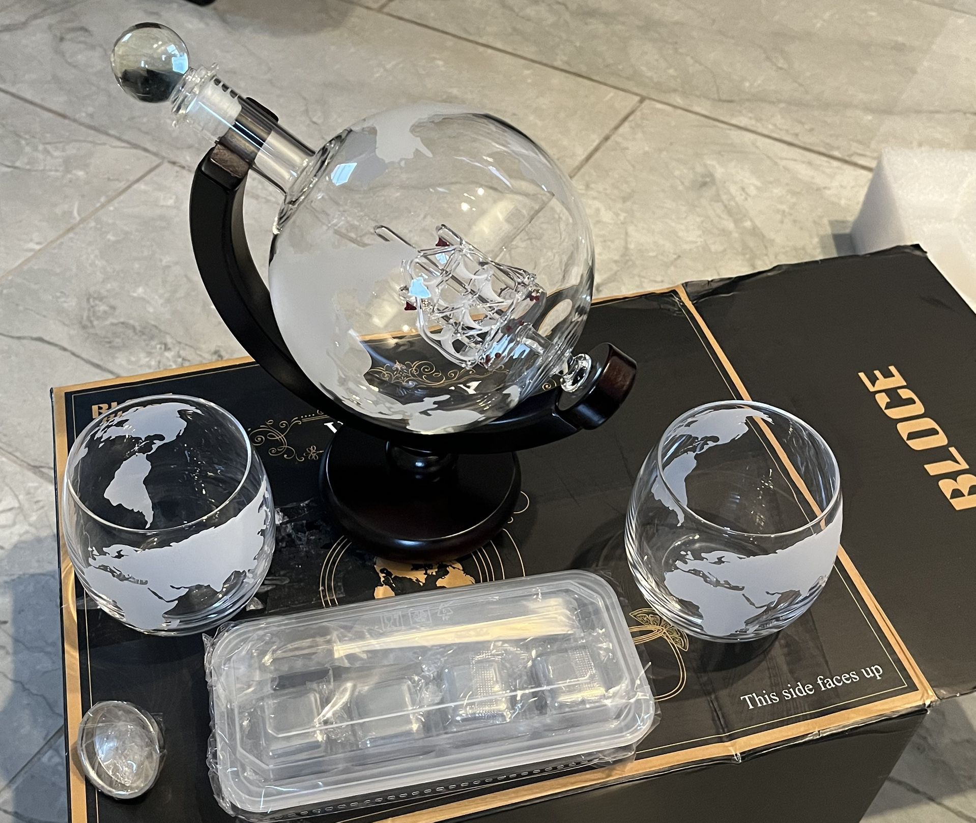Whiskey decanter set with glasses.  Globe with Ship in a bottle.