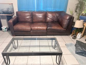 Brown leather couch with coffee table
