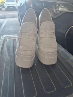 Glossy white platforms or disco shoes