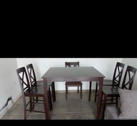 Wood dining table with 5 chairs and long sofa